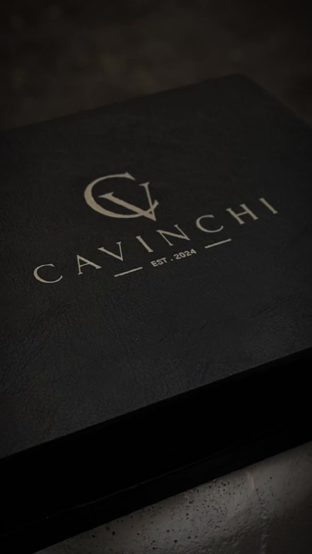 The rigid black box, the mark foiled on the lid