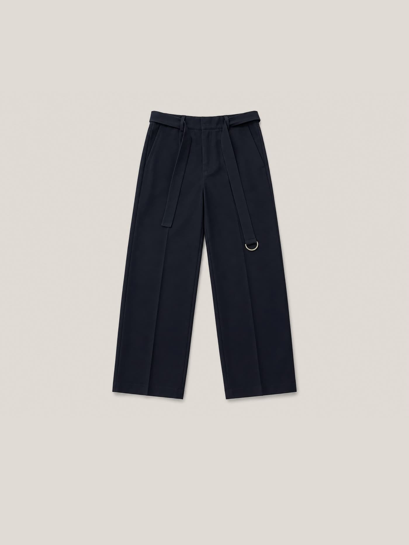 The navy trouser laid flat, self-fabric belt closed on a gold D-ring